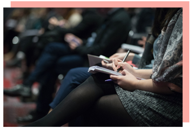 women-in-auditorium-meeting-pink-frame